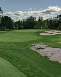 Muskoka golf green with rock and bunkers